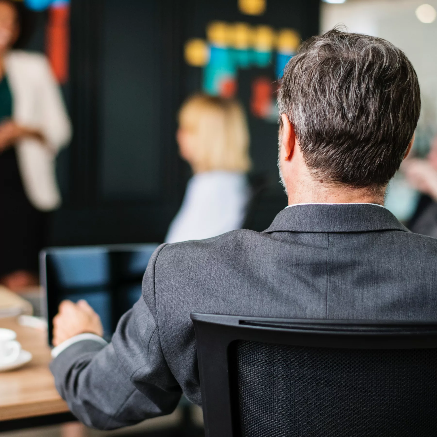 back of a businessman sitting in a presentation