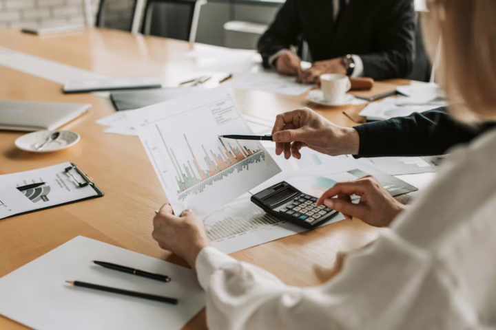 business people looking at and discussing data graphs