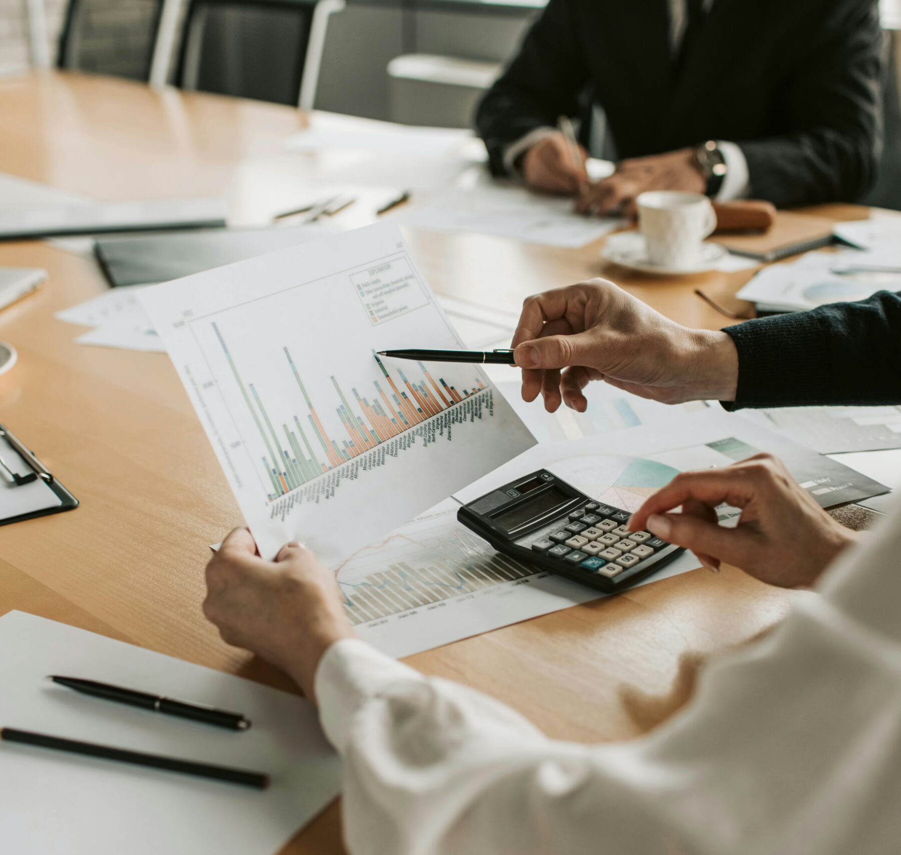 business people looking at and discussing data graphs