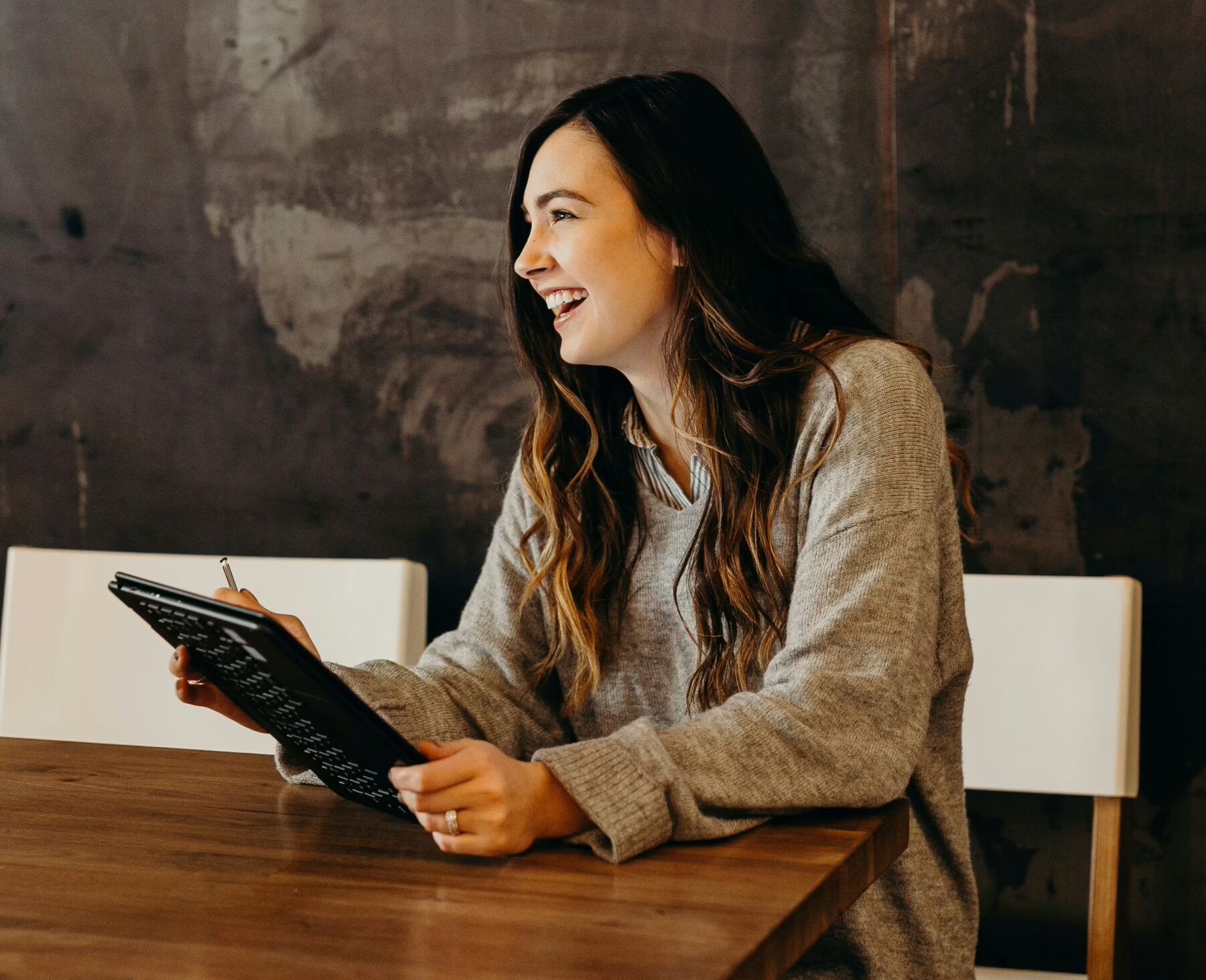 hr manager sitting at a table with tablet