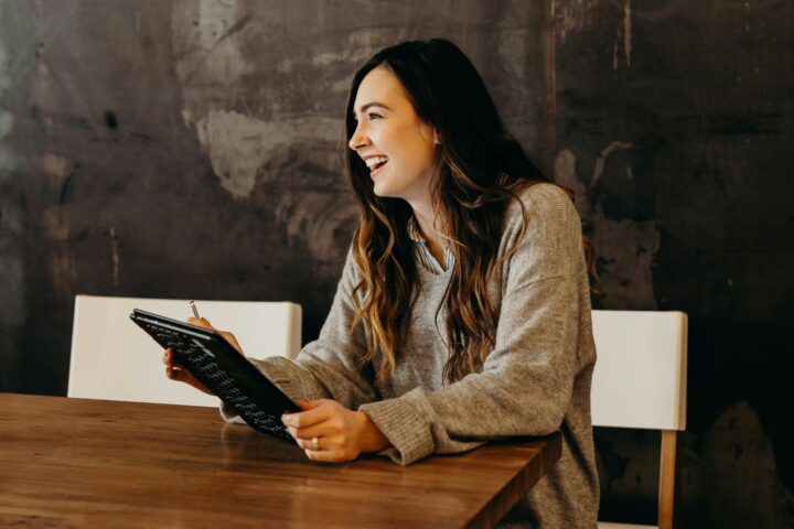 hr manager sitting at a table with tablet
