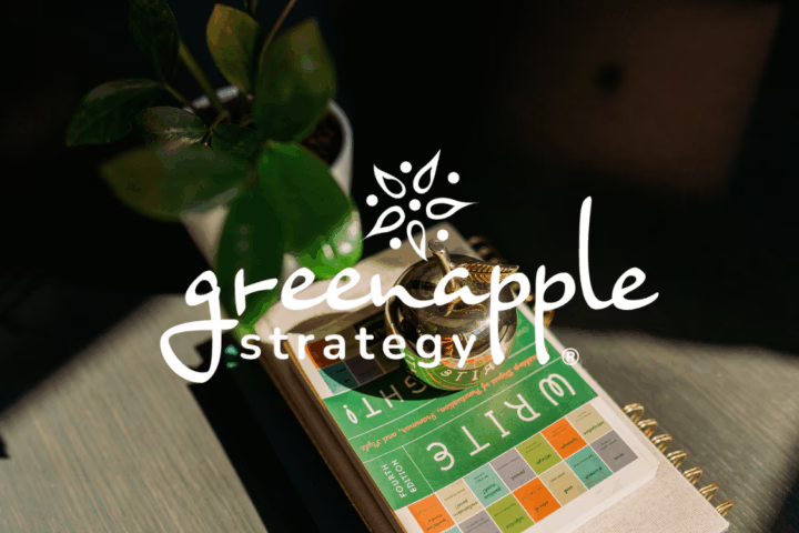 Green Apple Strategy logo over a golden apple