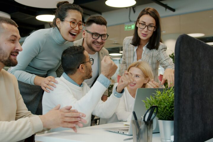 hr team talking in an excited way in the office