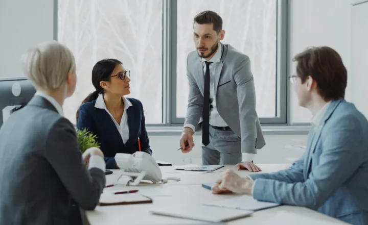 four business people having discussion in conference room