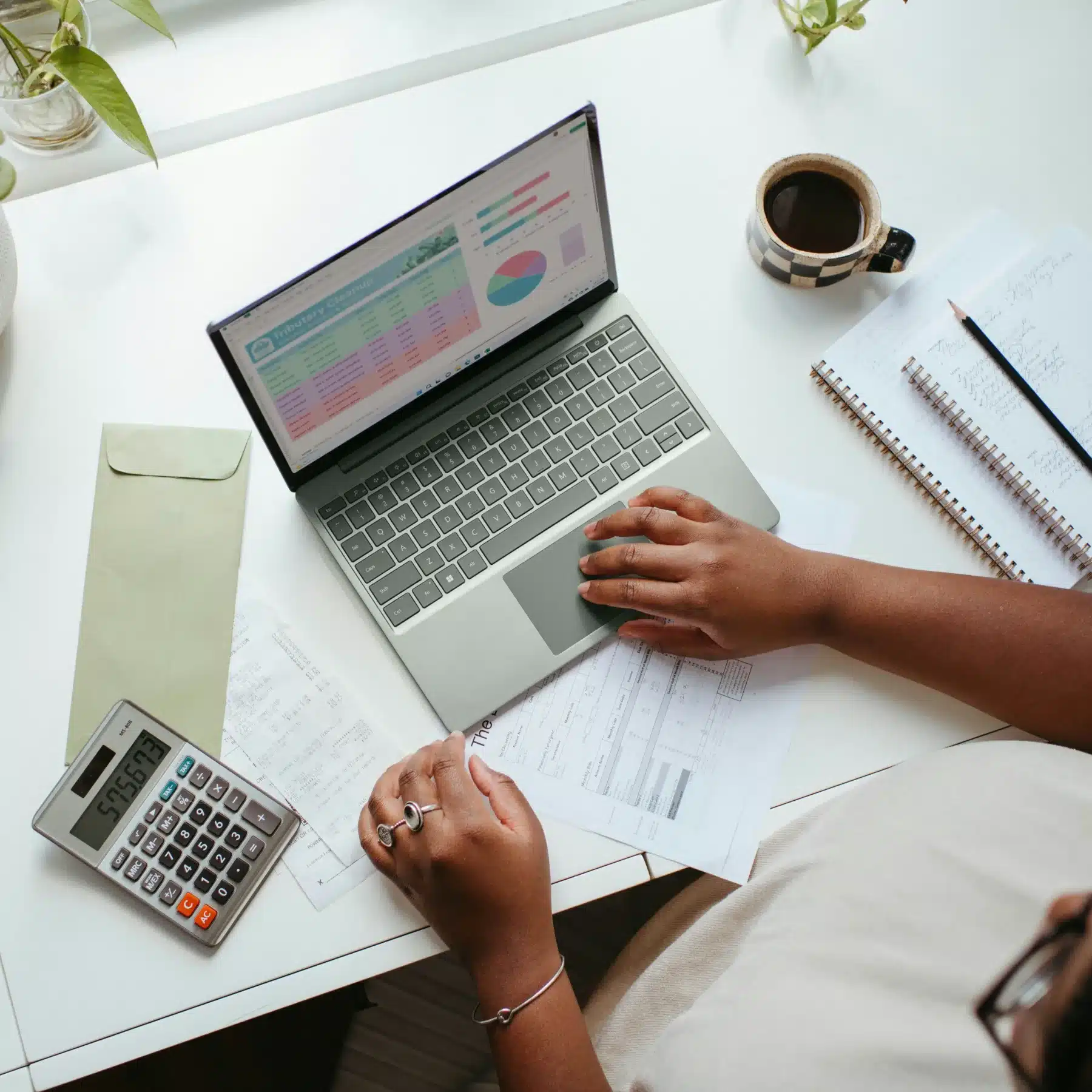 hr professional using laptop and calculator at desk