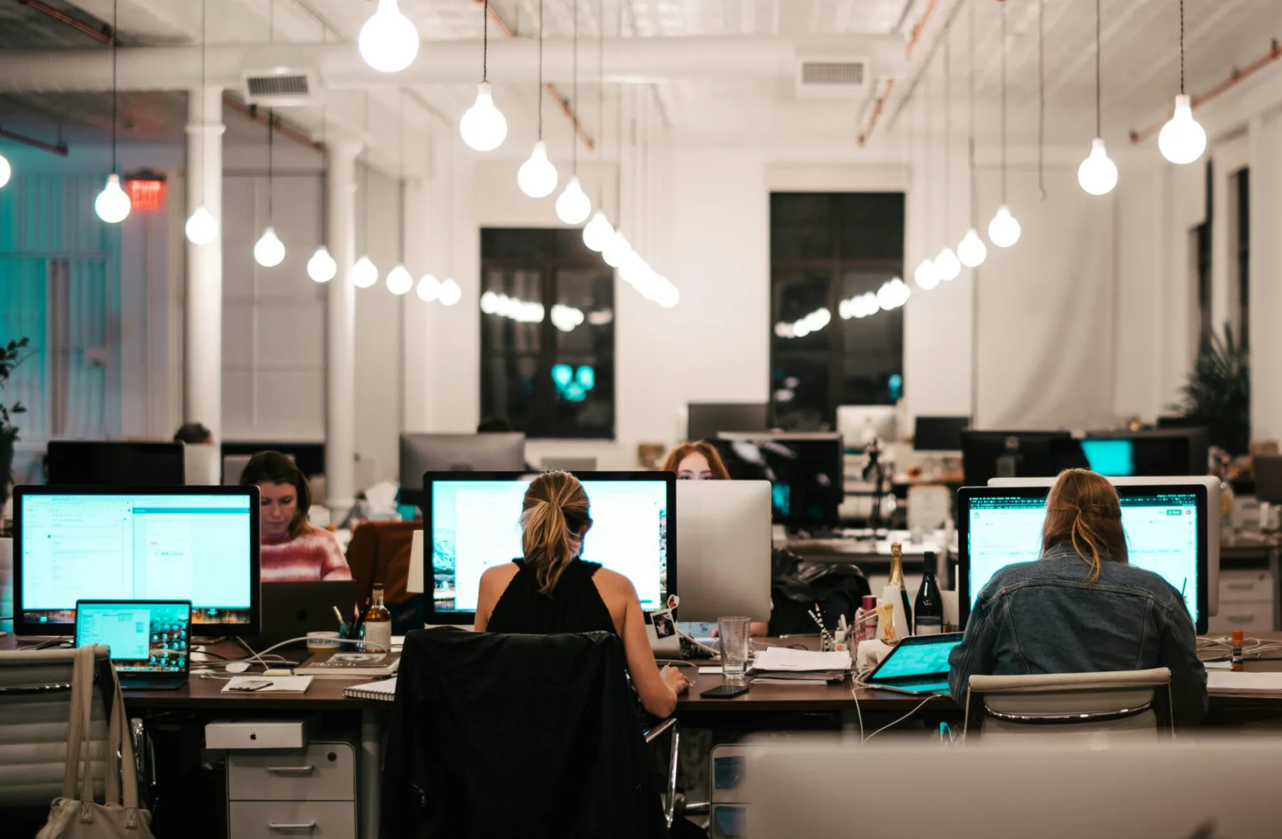 employees in open concept office space at night