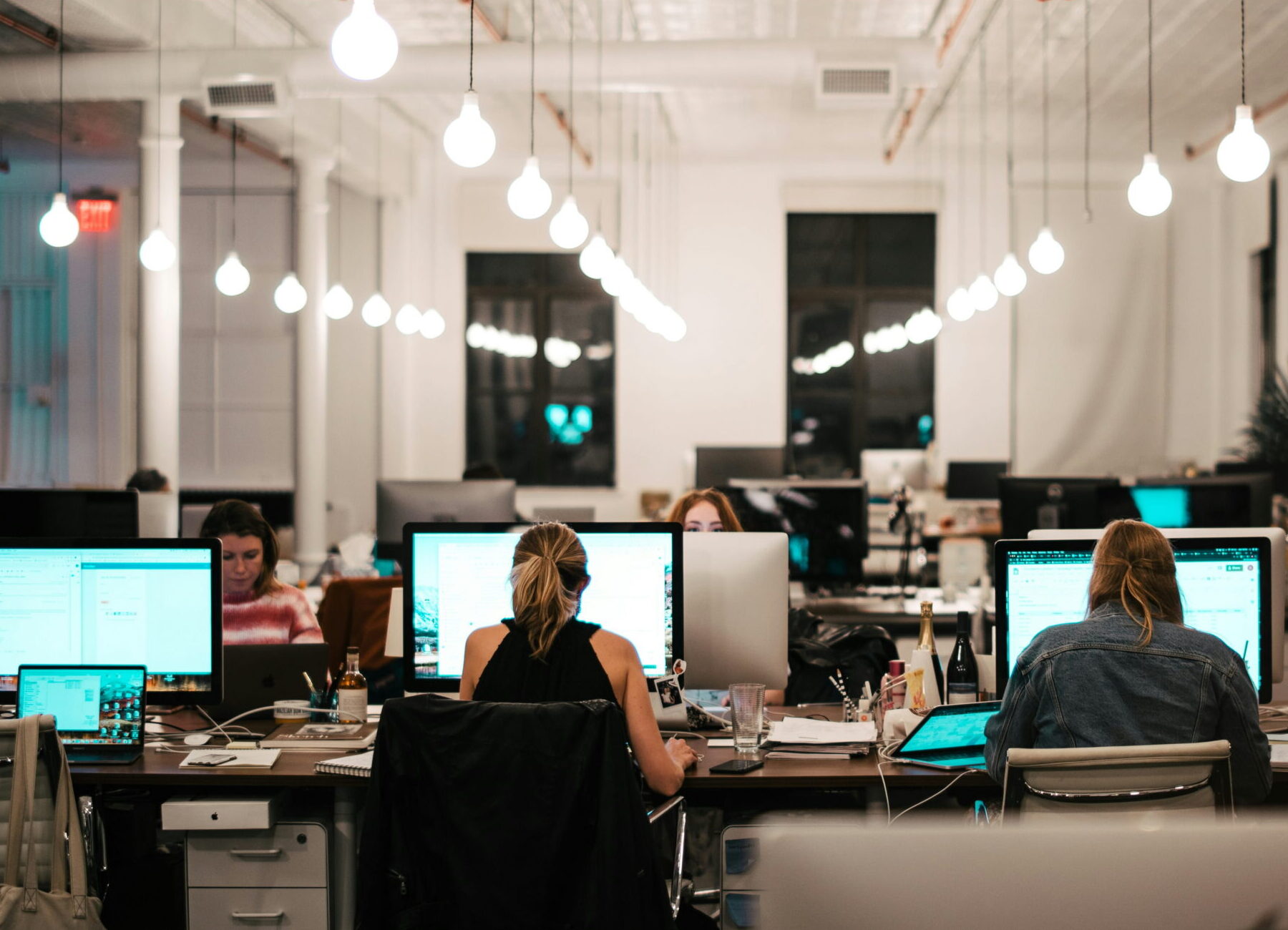 employees in open concept office space at night