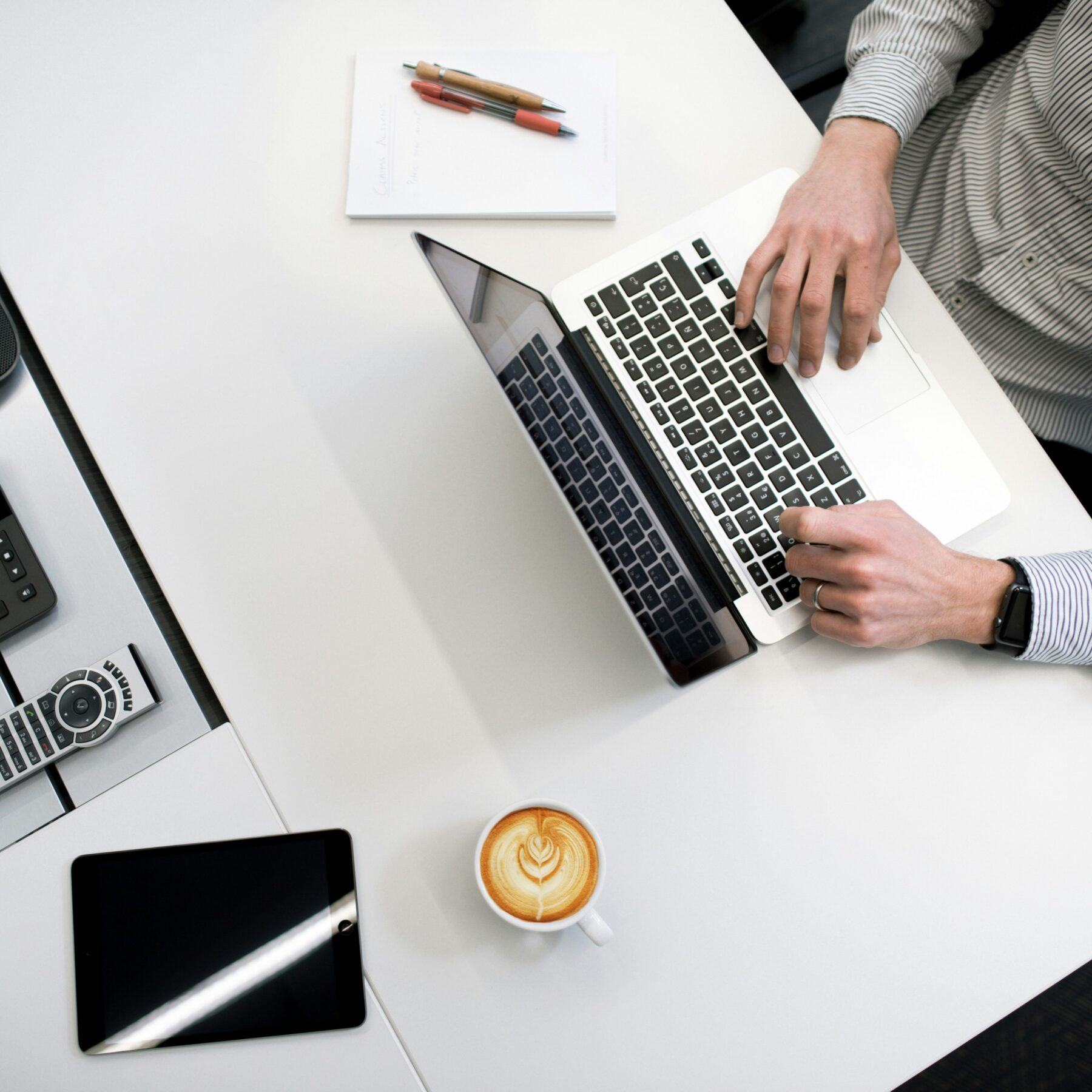 person using laptop at office desk