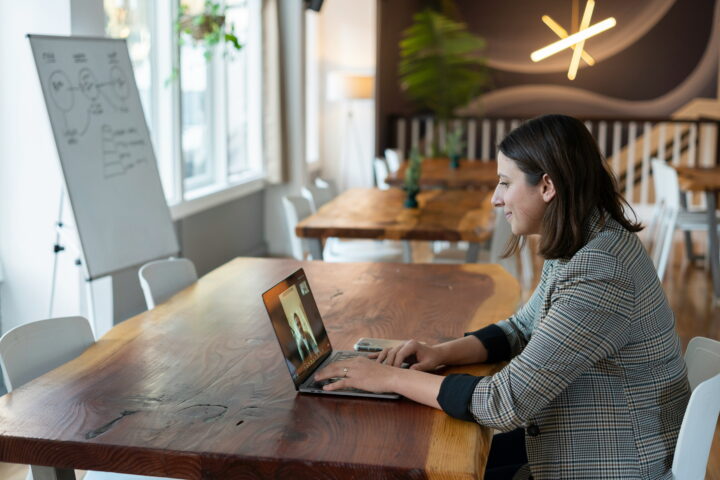 woman taking call from computer