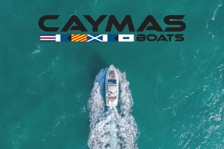 caymas boats logo and boat cruising through ocean