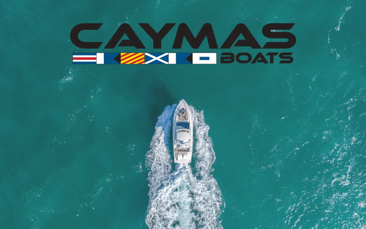 caymas boats logo and boat cruising through ocean