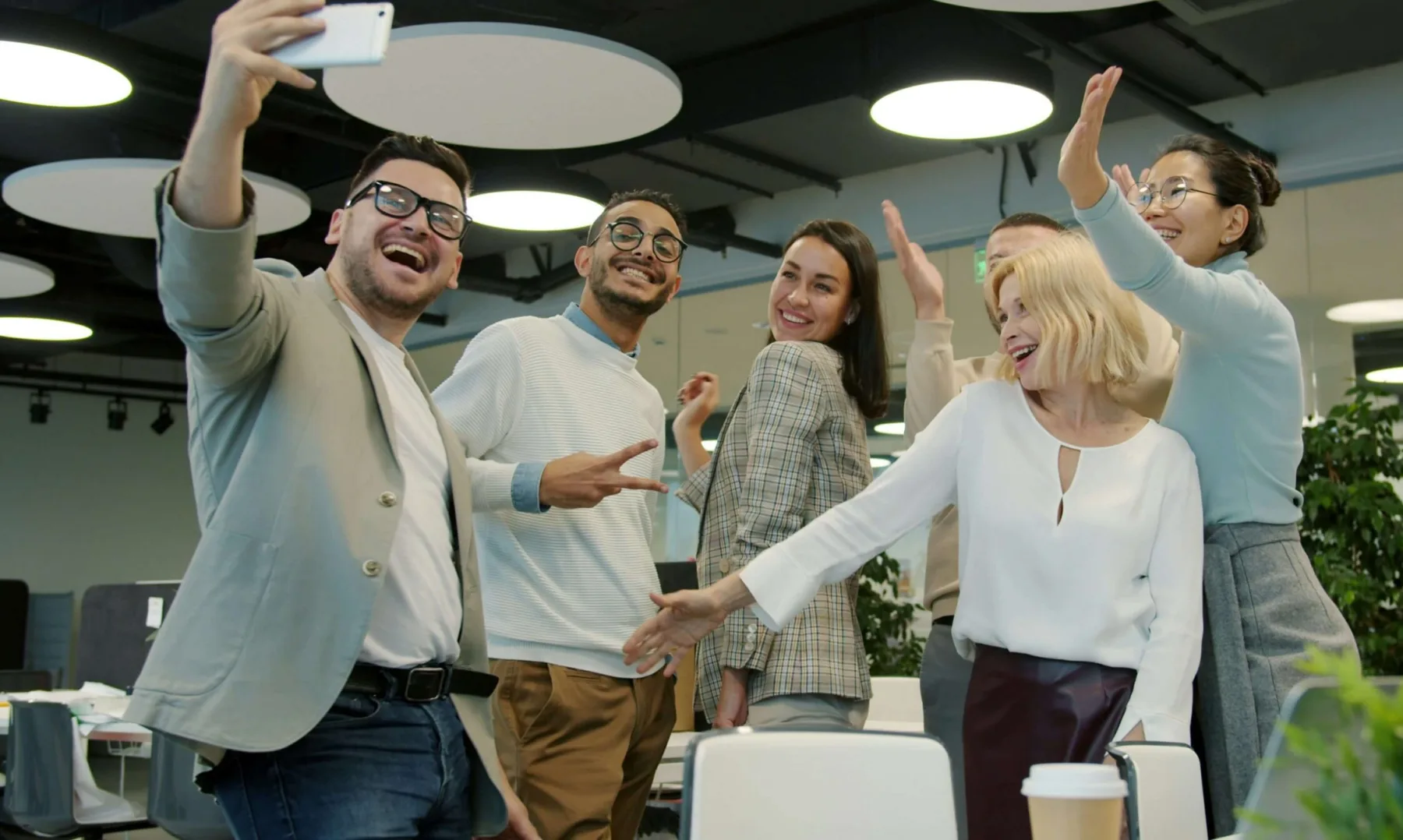 work colleagues excitedly posing for a photo together