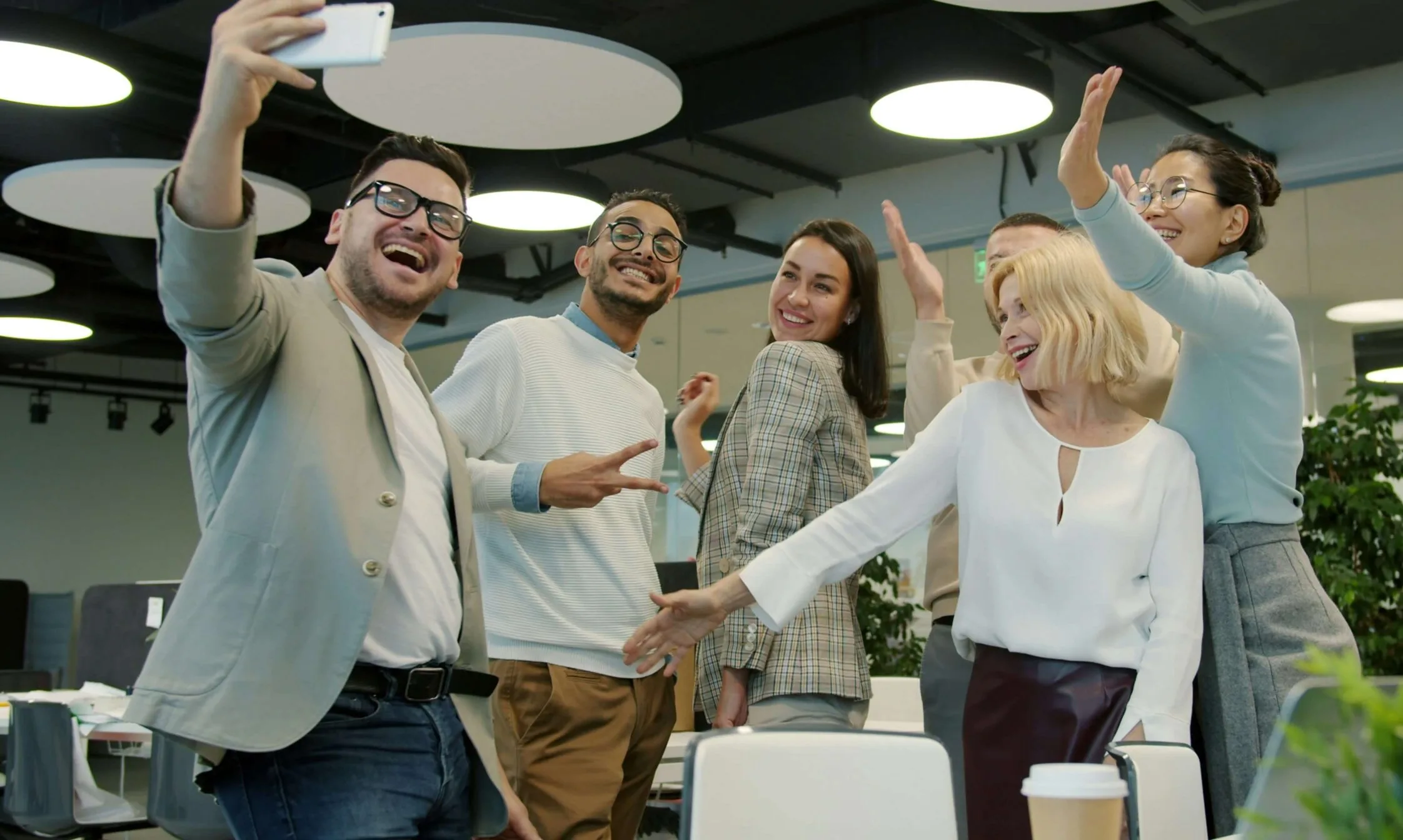 work colleagues excitedly posing for a photo together