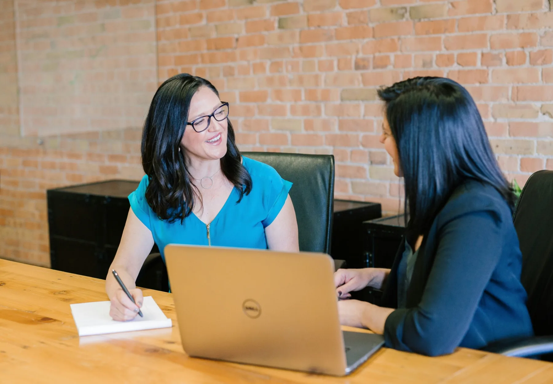two women working together in conference room
