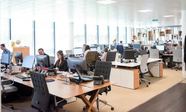 open concept office space with employees working at desks